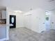 Open concept living space with a view of the kitchen and decorative front door with closet at 22131 Bahama Ave, Port Charlotte, FL 33952
