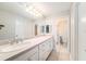 Well-lit bathroom featuring neutral countertops, white cabinetry, and ample counter space at 3419 Pleasant Lake Dr, Tampa, FL 33618