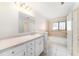 Bathroom featuring a neutral vanity with bright mirror and a shower and tub combination at 3419 Pleasant Lake Dr, Tampa, FL 33618