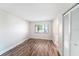 Cozy bedroom showcasing wood floors, a window for natural light, and a closet at 3419 Pleasant Lake Dr, Tampa, FL 33618
