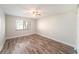 Bedroom features wood floors, a window for natural light, and a ceiling fan at 3419 Pleasant Lake Dr, Tampa, FL 33618