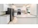Well-lit kitchen features stone countertops, tile flooring, and stainless steel appliances at 3419 Pleasant Lake Dr, Tampa, FL 33618