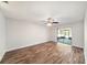 Spacious living room boasts wood floors and sliding glass doors leading to a screened lanai at 3419 Pleasant Lake Dr, Tampa, FL 33618