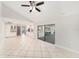 Open floor plan boasts tile flooring, a fan, and a sliding glass door leading to the outside at 3419 Pleasant Lake Dr, Tampa, FL 33618