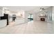 An open living space features a gas fireplace, tile flooring, and an attached kitchen at 3419 Pleasant Lake Dr, Tampa, FL 33618