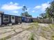 Exterior view of backyard, including blue and gray painted buildings at 5213 Keene Dr, Plant City, FL 33566