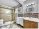 Bathroom featuring a modern vanity with a mosaic mirror and a tile-enclosed shower with glass door at 5213 Keene Dr, Plant City, FL 33566