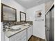 Elegant bathroom featuring dual vessel sinks, decorative tile backsplash, framed mirrors, and a glass-enclosed shower at 5213 Keene Dr, Plant City, FL 33566