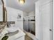 Updated bathroom with a glass shower enclosure, double sink with designer backsplash and tiled floors at 5213 Keene Dr, Plant City, FL 33566