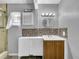 Cozy bathroom with storage vanity, tiled backsplash, shower with glass door, and decorative lighting fixtures at 5213 Keene Dr, Plant City, FL 33566