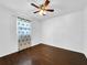 Bright bedroom featuring hardwood floors and large windows, creating a warm and inviting atmosphere at 5213 Keene Dr, Plant City, FL 33566