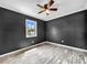A bedroom featuring tile flooring, a window, and neutral-colored walls at 5213 Keene Dr, Plant City, FL 33566