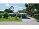 Charming single-story home with a covered carport and well-maintained front lawn at 5213 Keene Dr, Plant City, FL 33566