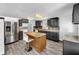 Modern kitchen featuring an island, stainless steel appliances, and an open floorplan at 5213 Keene Dr, Plant City, FL 33566