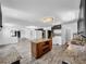 Open-concept kitchen with island and stainless steel appliances overlooking the living room at 5213 Keene Dr, Plant City, FL 33566