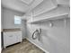 Laundry room featuring built-in cabinetry, shelving, and a granite countertop, providing a functional and organized space at 5213 Keene Dr, Plant City, FL 33566