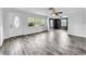 Bright living room features elegant wood-look tile flooring and fresh white walls at 5213 Keene Dr, Plant City, FL 33566