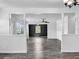 Open-concept living room showcasing wood-look tile flooring, fresh white walls, and an adjacent room at 5213 Keene Dr, Plant City, FL 33566