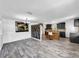 Open-concept living room and kitchen featuring wood accents and stylish floors at 5213 Keene Dr, Plant City, FL 33566