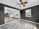 Living room featuring wood-look tile flooring and neutral-colored walls at 5213 Keene Dr, Plant City, FL 33566