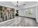 Stylish living room featuring wood accent wall, natural light, and stylish floors at 5213 Keene Dr, Plant City, FL 33566