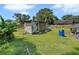 Exterior side view of wooden shed in grassy backyard at 5213 Keene Dr, Plant City, FL 33566