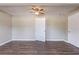 Bedroom with wood-look floors, neutral walls and an open door at 1409 N Garden Ave, Clearwater, FL 33755