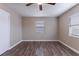 Bright bedroom featuring wood-look floors, neutral walls, and a modern ceiling fan at 1409 N Garden Ave, Clearwater, FL 33755