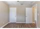 Bedroom features wood-look flooring, neutral walls and two closets at 1409 N Garden Ave, Clearwater, FL 33755
