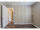 Bedroom featuring wood-look flooring, neutral walls and a doorway leading to another room at 1409 N Garden Ave, Clearwater, FL 33755