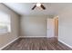 Bright bedroom featuring wood-look floors, neutral walls, ceiling fan, and closet door at 1409 N Garden Ave, Clearwater, FL 33755