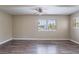 Spacious living room with natural light, wood-look floors, and a ceiling fan at 1409 N Garden Ave, Clearwater, FL 33755