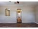 Open living area with unique archways, wood flooring, and neutral paint throughout at 1409 N Garden Ave, Clearwater, FL 33755