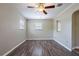 Bright living room with modern ceiling fan, neutral walls, and stylish wood flooring at 1409 N Garden Ave, Clearwater, FL 33755