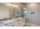 Modern bathroom featuring double sinks, granite countertops, and glass shower enclosure at 4150 Windsong Ave, North Port, FL 34287