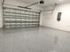 Spacious two-car garage with a sealed floor and garage door opener at 4150 Windsong Ave, North Port, FL 34287