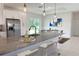 Modern kitchen with stainless steel appliances, gray countertop and a breakfast bar with stools at 4150 Windsong Ave, North Port, FL 34287