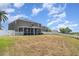 Rear exterior view highlighting the fenced yard and screened-in porch feature at 541 Vista Ridge Dr, Ruskin, FL 33570
