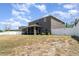Exterior view of the home showing a screened-in porch and fenced-in backyard at 541 Vista Ridge Dr, Ruskin, FL 33570