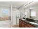 Bathroom featuring double vanity, granite countertops, tub, and shower at 541 Vista Ridge Dr, Ruskin, FL 33570