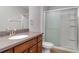 Bathroom showcasing a vanity, granite countertop, and glass-enclosed shower at 541 Vista Ridge Dr, Ruskin, FL 33570