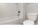 Bathroom showcasing white tile, tub, shower head, and toilet at 541 Vista Ridge Dr, Ruskin, FL 33570