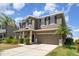 Inviting home featuring a manicured lawn, two car garage, and a well maintained driveway at 541 Vista Ridge Dr, Ruskin, FL 33570