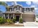 Charming two-story home featuring a well-maintained lawn, black shutters, and a two-car garage at 541 Vista Ridge Dr, Ruskin, FL 33570