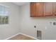 Well-lit laundry room with tile floors, storage cabinets and hookups for appliances at 541 Vista Ridge Dr, Ruskin, FL 33570