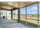 Screened-in porch offering serene views of the outdoor area and a nearby pond at 541 Vista Ridge Dr, Ruskin, FL 33570