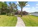 Well-manicured backyard with lush lawn, mature trees, and patio area for outdoor living at 2818 Mossy Timber Trl, Valrico, FL 33596