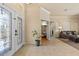 Bright foyer with tile flooring, decorative glass front doors, and an open view to the living room at 2818 Mossy Timber Trl, Valrico, FL 33596