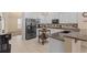 Stylish kitchen with white cabinets, stainless steel appliances, granite countertops, and a cozy breakfast nook at 2818 Mossy Timber Trl, Valrico, FL 33596