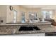 Modern kitchen featuring granite countertops, a deep sink and stainless steel appliances, seamlessly connecting to the living area at 2818 Mossy Timber Trl, Valrico, FL 33596